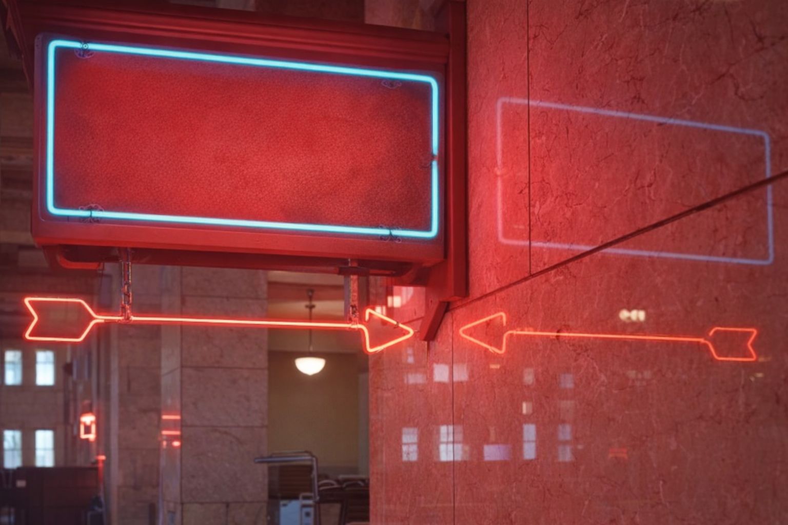 En röd neonskylt med en pil som pekar in mot en byggnad.